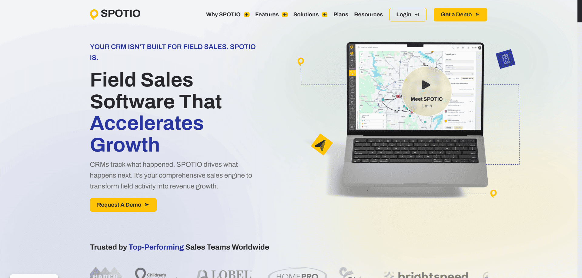 SPOTIO homepage showing a laptop with a map, bold headline on sales growth, demo request buttons, and trusted brand logos below.